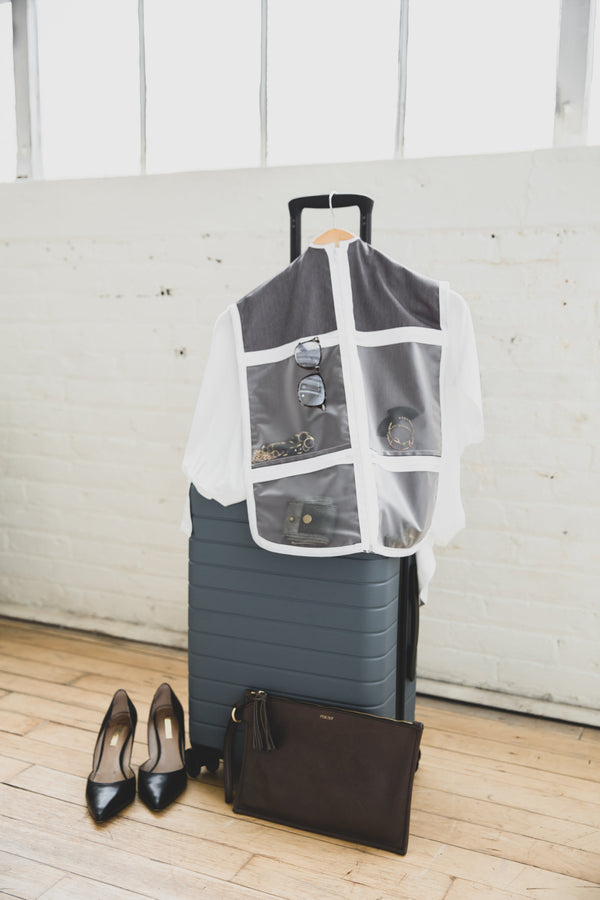 The Hanger Valet used as a travel organizer with a suitcase, purse and shoes